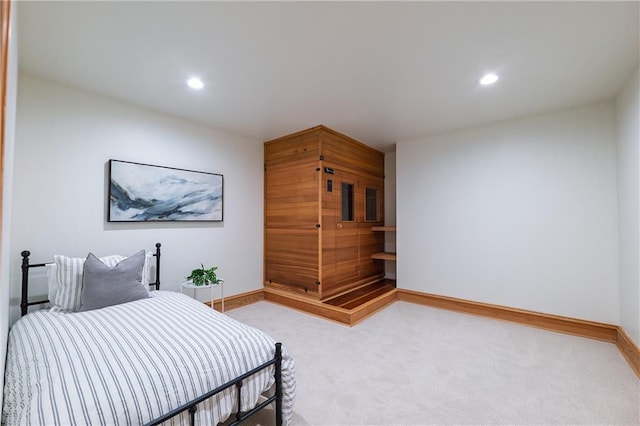 bedroom with baseboards, recessed lighting, and light colored carpet