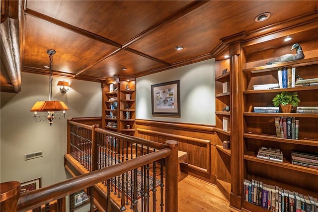 wine cellar featuring wood finished floors, visible vents, wooden ceiling, ornamental molding, and recessed lighting