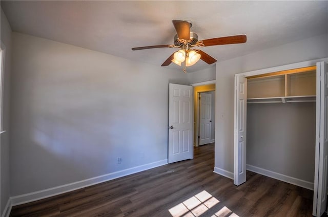 unfurnished bedroom with dark hardwood / wood-style floors, a closet, and ceiling fan