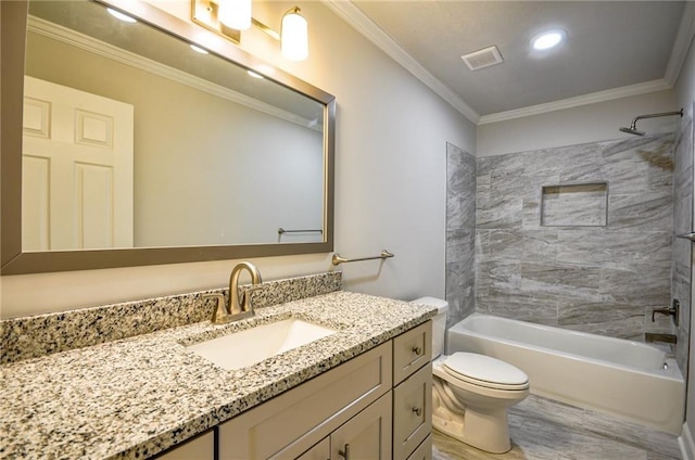 full bathroom featuring tiled shower / bath, vanity, crown molding, and toilet