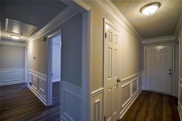hallway featuring ornamental molding, a textured ceiling, and dark hardwood / wood-style flooring