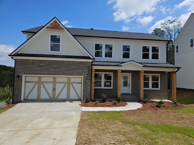 129 Silvercrest Dr, Acworth, GA 30101 - view of front of home featuring brick siding, concrete driveway, a garage, and board and batten siding