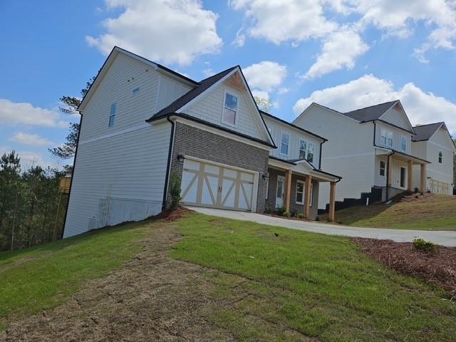 129 Silvercrest Dr, Acworth, GA 30101 - view of front of house with an attached garage, a front yard, and concrete driveway