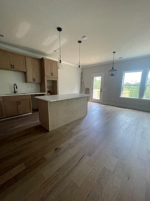 129 Silvercrest Dr, Acworth, GA 30101 - kitchen with crown molding, dark wood-style flooring, a center island, and a sink