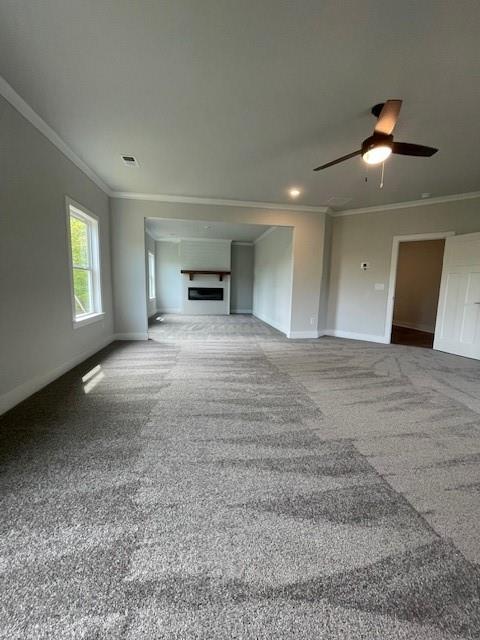 129 Silvercrest Dr, Acworth, GA 30101 - unfurnished living room with crown molding, carpet, baseboards, ceiling fan, and a fireplace
