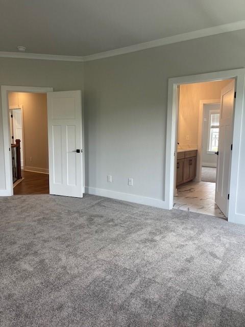 129 Silvercrest Dr, Acworth, GA 30101 - unfurnished bedroom with carpet, crown molding, baseboards, and connected bathroom
