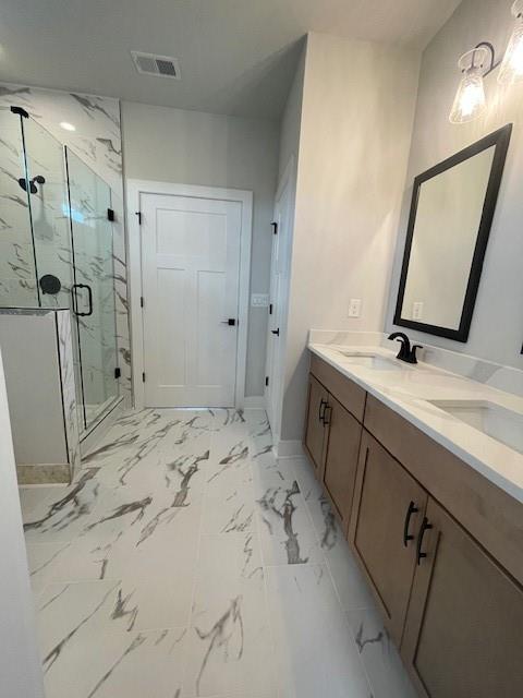 129 Silvercrest Dr, Acworth, GA 30101 - bathroom featuring a marble finish shower, double vanity, baseboards, and marble look tile flooring
