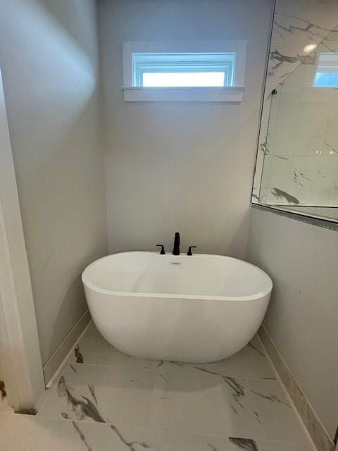 129 Silvercrest Dr, Acworth, GA 30101 - full bath with marble look tiles, a freestanding bath, and baseboards