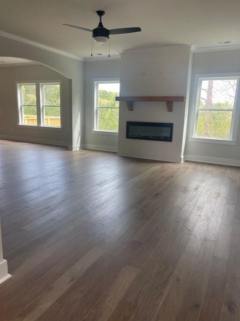 129 Silvercrest Dr, Acworth, GA 30101 - unfurnished living room with baseboards, crown molding, dark wood-type flooring, a glass covered fireplace, and a ceiling fan