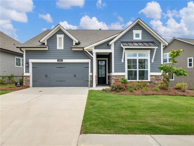 craftsman-style home featuring a garage and a front lawn