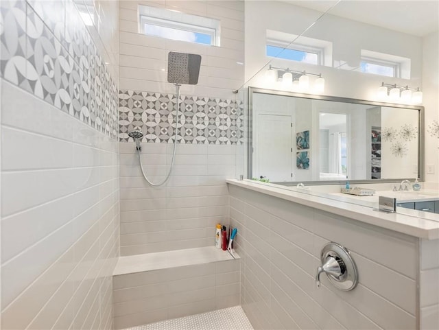 bathroom with sink and a tile shower