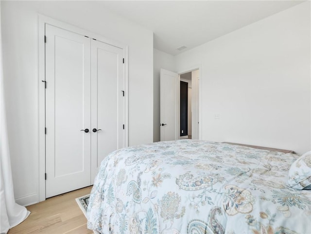 bedroom featuring light wood-type flooring and a closet