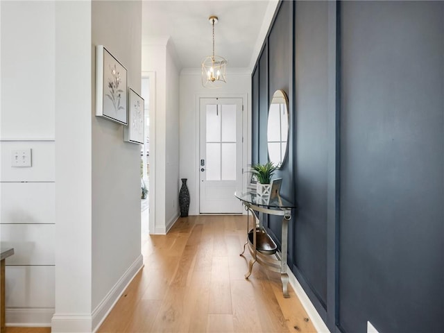 foyer featuring a chandelier and light hardwood / wood-style floors