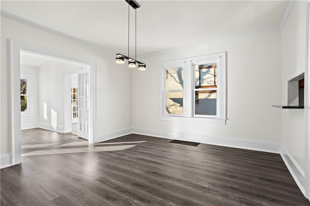 unfurnished dining area featuring dark hardwood / wood-style flooring and crown molding