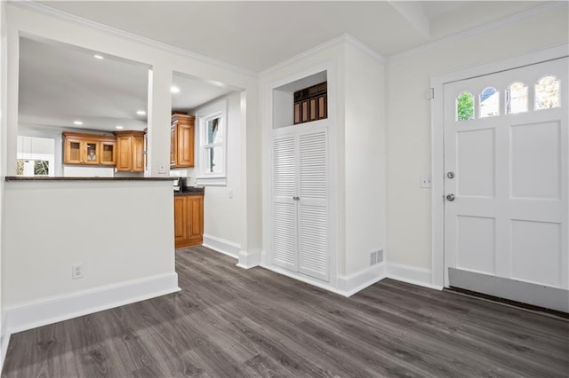 entrance foyer featuring dark hardwood / wood-style flooring and ornamental molding