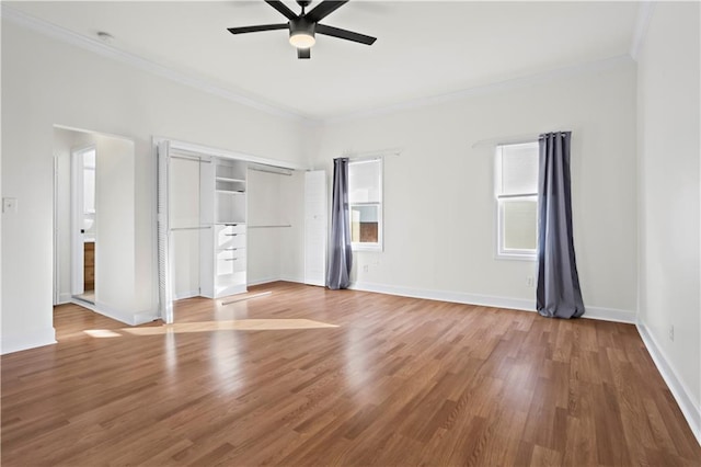 unfurnished bedroom featuring ceiling fan, crown molding, and hardwood / wood-style flooring