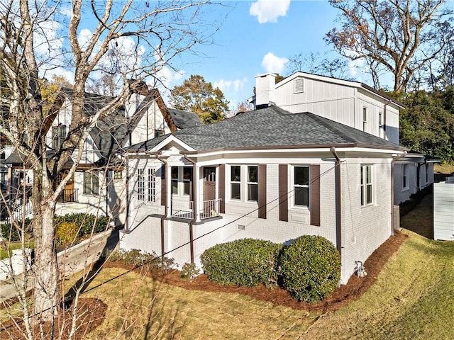 rear view of house featuring a yard