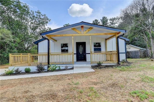 view of front facade featuring covered porch and board and batten siding