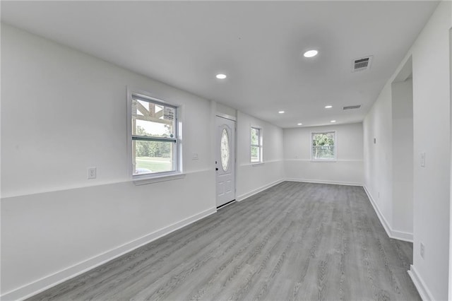 foyer featuring recessed lighting, baseboards, visible vents, and wood finished floors