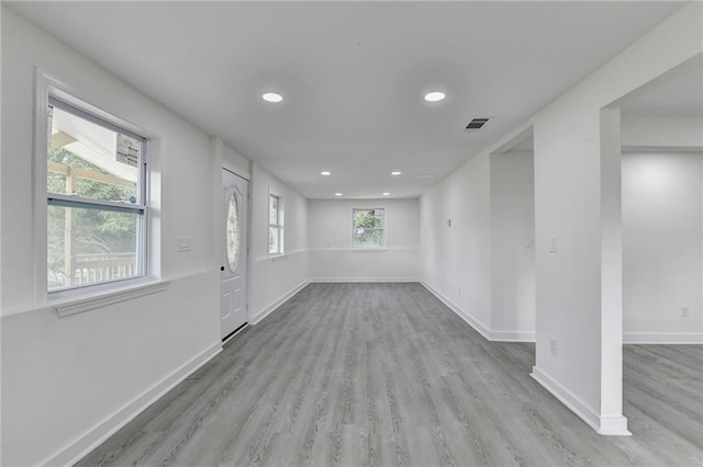 empty room featuring baseboards, visible vents, wood finished floors, and recessed lighting