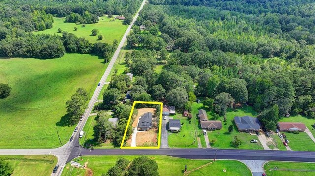 birds eye view of property with a view of trees