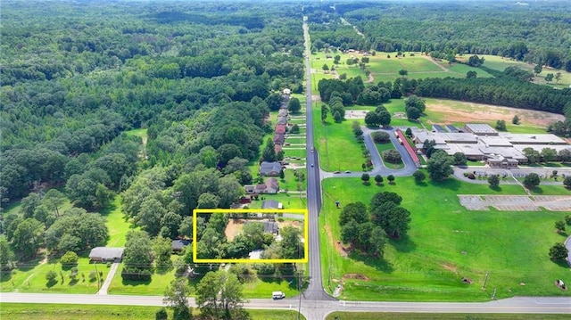 birds eye view of property with a wooded view