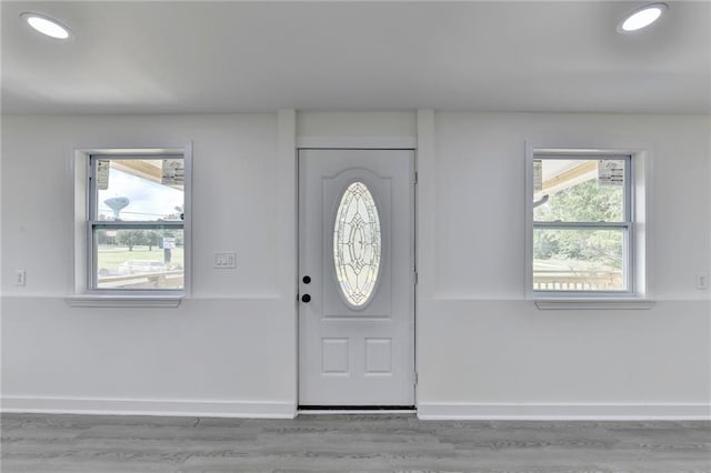 entrance foyer with baseboards, wood finished floors, and recessed lighting