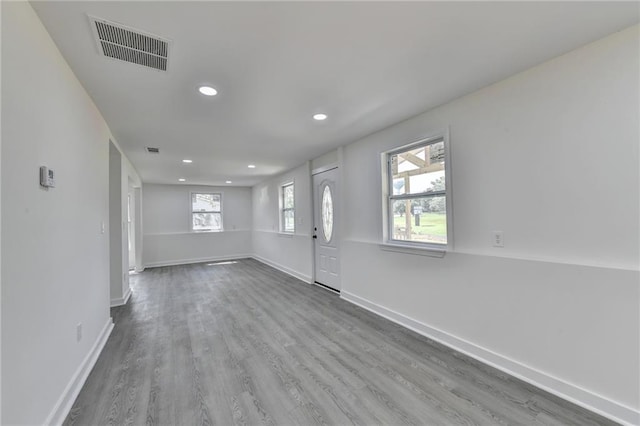 foyer with wood finished floors, recessed lighting, baseboards, and visible vents