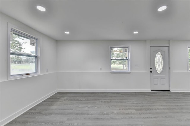 foyer featuring baseboards, light wood-style floors, and recessed lighting