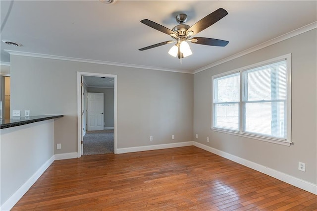 spare room featuring ornamental molding, wood-type flooring, and ceiling fan