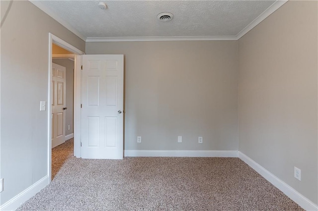 carpeted spare room featuring ornamental molding and a textured ceiling