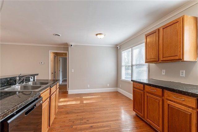 kitchen with sink, light hardwood / wood-style flooring, ornamental molding, black dishwasher, and dark stone counters