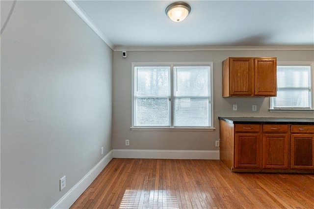 kitchen with ornamental molding and light hardwood / wood-style floors