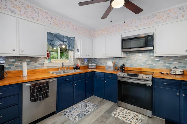 4223 Spring Valley Dr, Cohutta, GA 30710 - kitchen featuring stainless steel appliances, a sink, blue cabinetry, and butcher block countertops