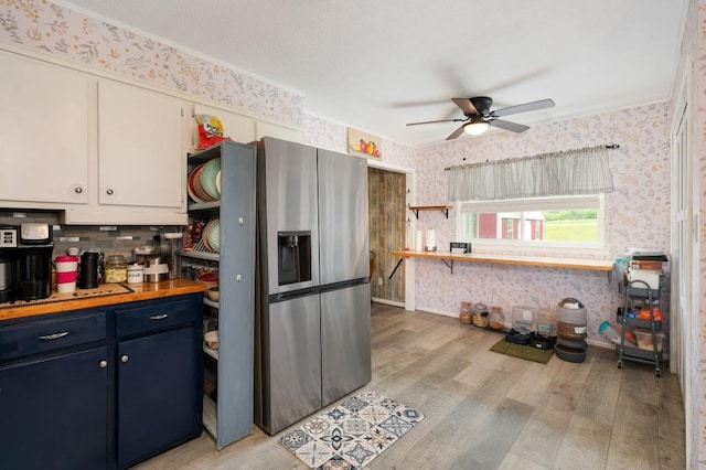 4223 Spring Valley Dr, Cohutta, GA 30710 - kitchen with wallpapered walls, stainless steel refrigerator with ice dispenser, ceiling fan, light wood finished floors, and blue cabinets