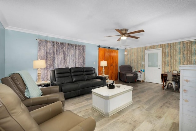 4223 Spring Valley Dr, Cohutta, GA 30710 - living room with crown molding, light wood-style flooring, ceiling fan, and a barn door