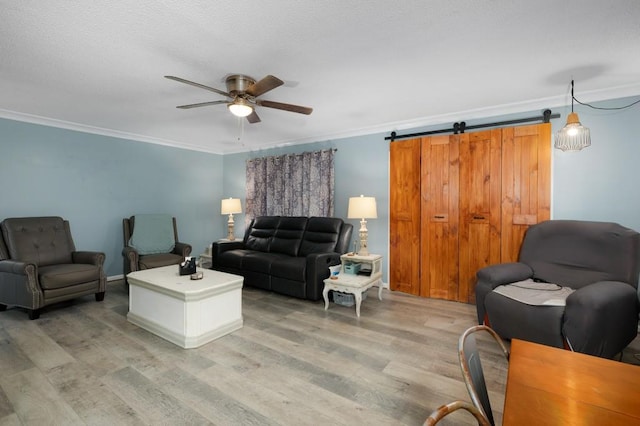 4223 Spring Valley Dr, Cohutta, GA 30710 - living area featuring light wood-style flooring, ceiling fan, crown molding, and a barn door