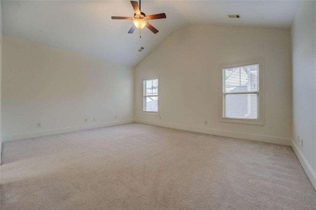 empty room featuring ceiling fan, high vaulted ceiling, and light carpet