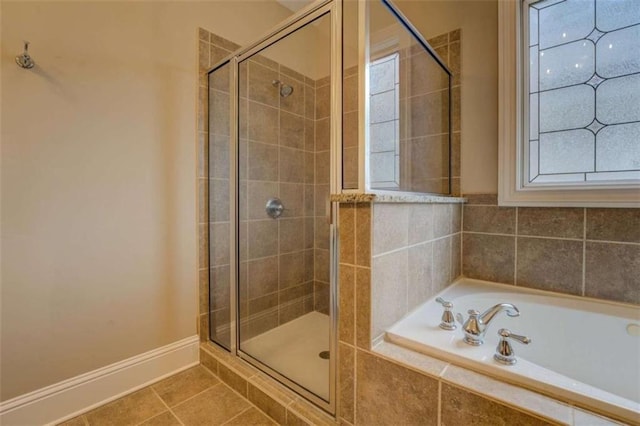 bathroom with plus walk in shower and tile patterned flooring