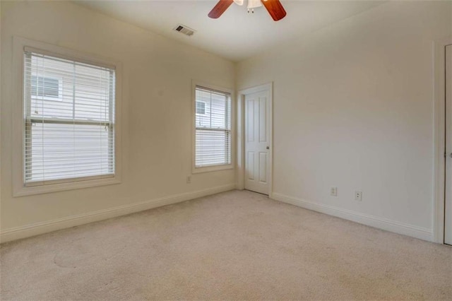 carpeted spare room with ceiling fan