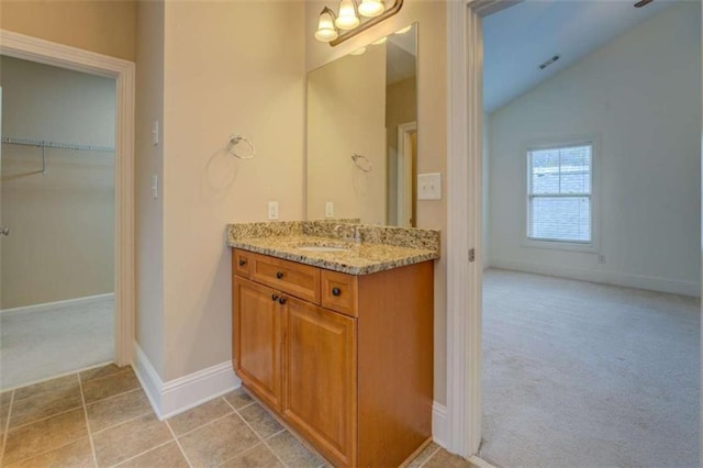 bathroom featuring lofted ceiling, vanity, and tile patterned floors