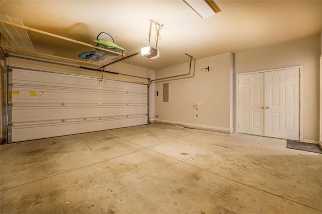 garage with a garage door opener and electric panel