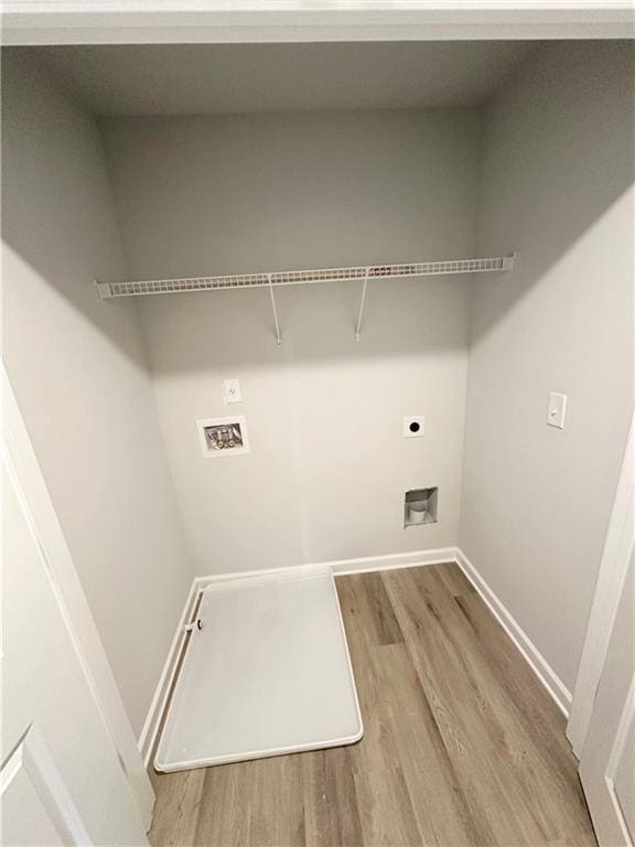 laundry room with hookup for a washing machine, electric dryer hookup, and light wood-type flooring