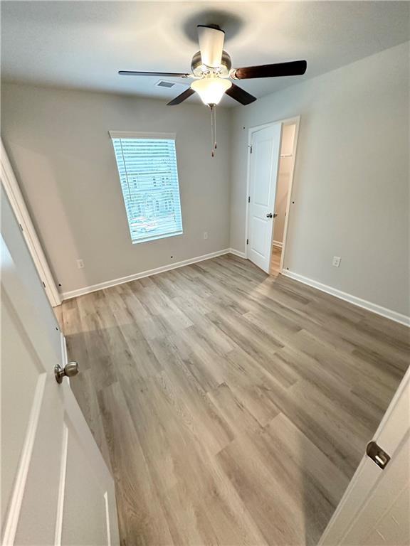 unfurnished bedroom with light hardwood / wood-style flooring and ceiling fan