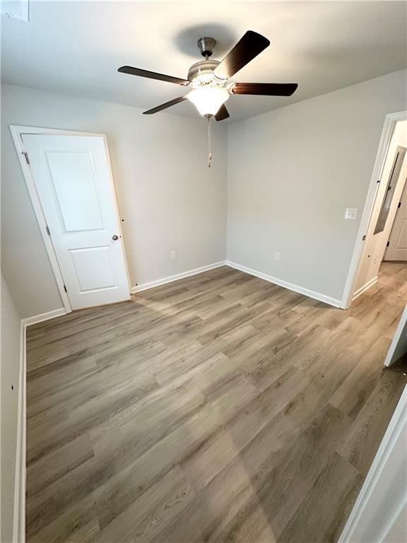 spare room featuring ceiling fan and light wood-type flooring