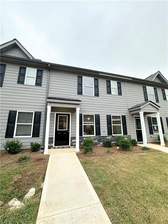 view of property featuring a front yard