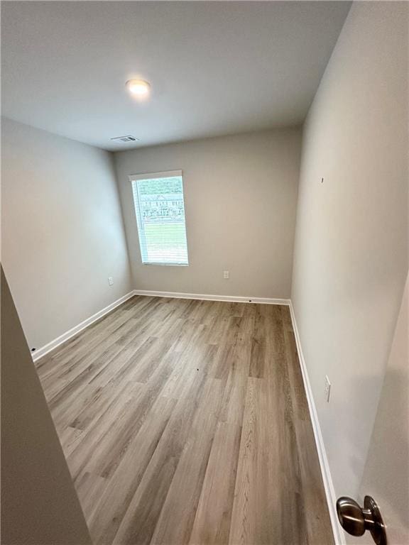 spare room featuring light hardwood / wood-style floors