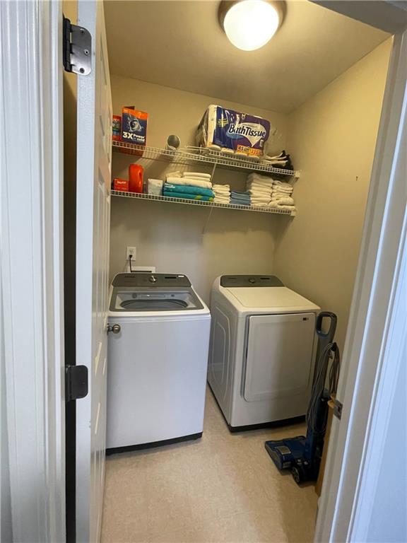 clothes washing area featuring washer and clothes dryer