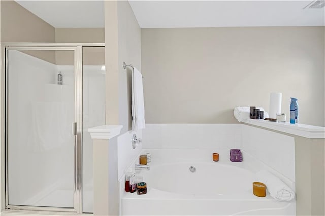 full bathroom with a shower stall, visible vents, and a bath