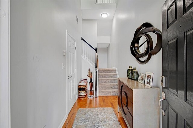 interior space featuring a high ceiling and light wood-type flooring